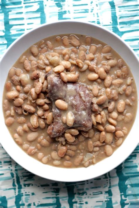 Dried pinto beans are soaked then simmered with meaty ham hocks and flavors galore reaching tender thick perfection! Pinto Beans With Ham Hocks Recipe | The Hungry Hutch