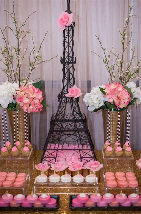 The Eiffel Tower Is Decorated With Pink Flowers And Cupcakes For Dessert