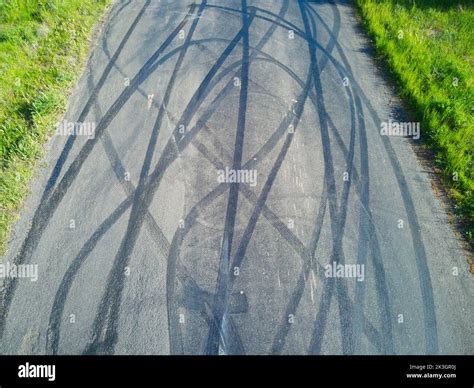 Tyre Marks On Road Aerial View Showing Skid Mark Patterns And Green