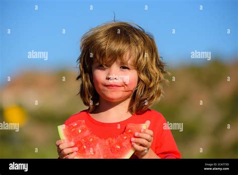 Boy Child Eating Watermelon With Funny Face Green Nature Background