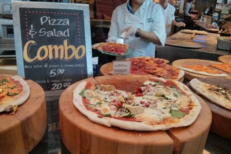 Pizza preparation design template with cheese, olives, salami, mushrooms, tomatoes, flour and other ingredients pizza with mushroom and tomato, chilli, herbs on board on wooden background. Pizza and salad combo at Whole Foods a steal for lunch ...