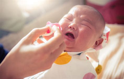 Newborn Baby Crying With Pacifier In Father Hand Stock