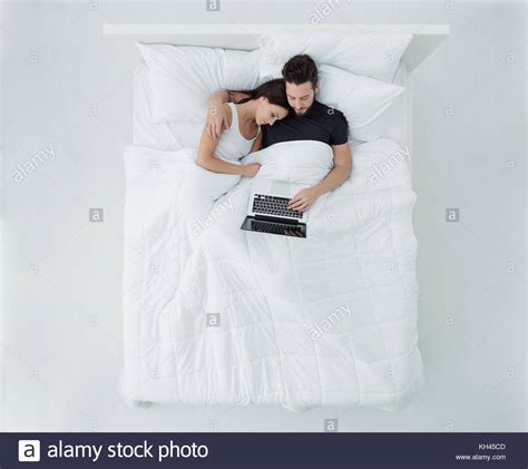 Loving Couple Relaxing In Bed They Are Hugging And Connecting With A