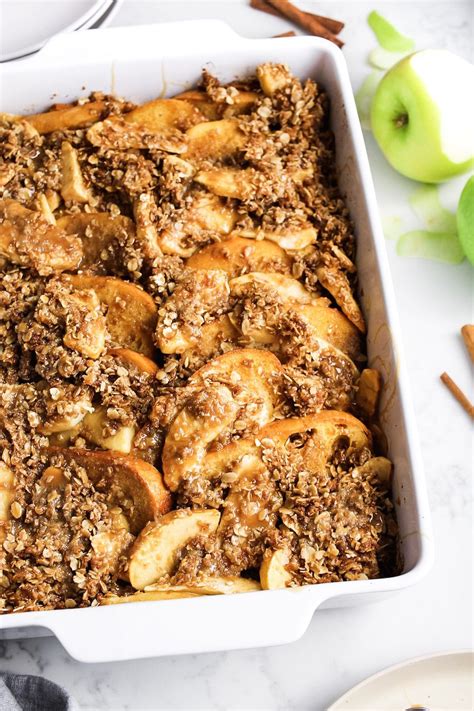 A Casserole Dish Filled With Apple Slices And Cinnamon Crumbled Toppings