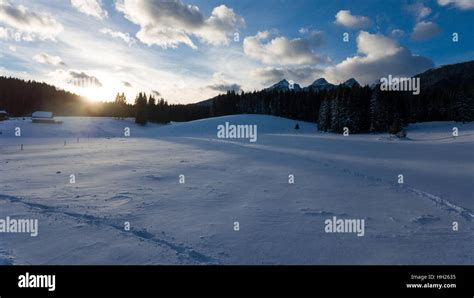 Sun Rising Above Snow Covered Meadow Stock Photo Alamy