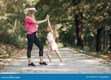 Mother With Daughter Doing Sport In A Summer Park Stock Image Image
