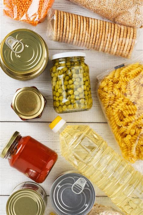 Various Canned Food And Raw Cereal Grains On A Table Stock Photo