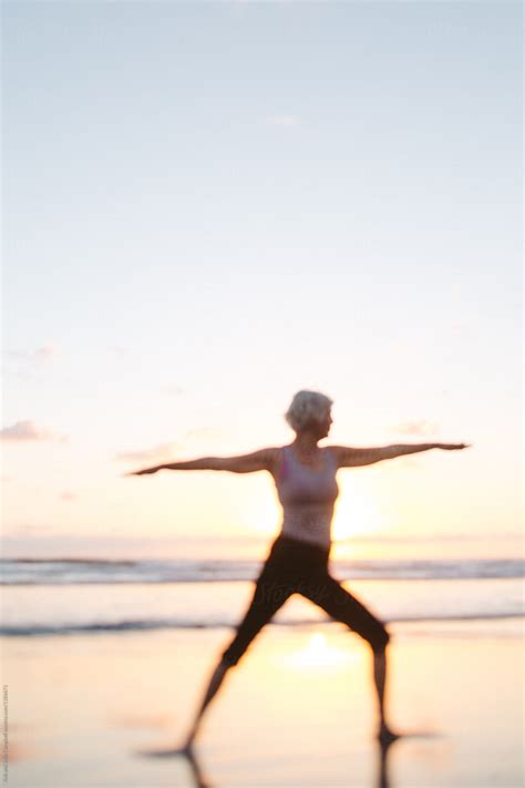 Vibrant Mature Woman Enjoying Herself On The Beach At Sunset Del