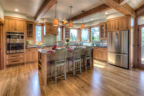 A Large Kitchen With Wooden Floors And An Island In Front Of The Stove