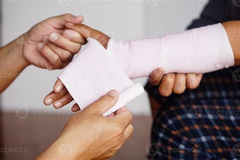 Closeup Mans Hands Are Wrapping Patients Sprained Wrist With Elastic