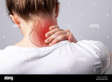 Woman Suffering From Neck Pain Head Back With Red Spot Closeup Health