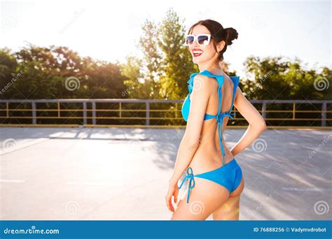 Side View Of A Beautiful Girl In Blue Swimsuit Posing Stock Photo