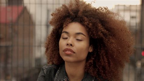 Black Mixed Race Woman With Big Afro Curly Hair In Urban Industrial