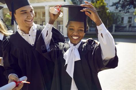 Portrait Of Happy African American Girl In Cap And Gown Having Fun On