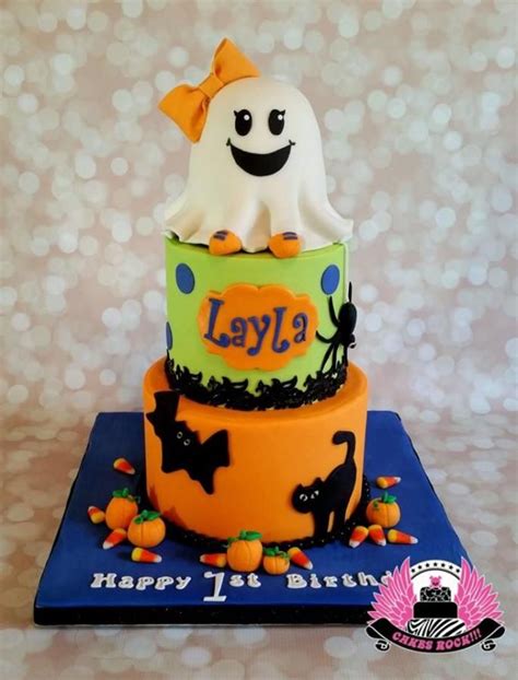 A Three Tiered Cake Decorated With Halloween Decorations