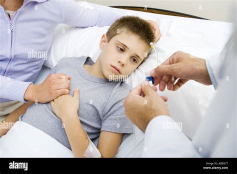 Boy Having Iv Drip Adjusted In Hospital Stock Photo Alamy