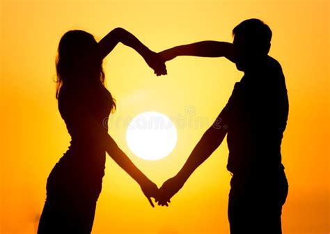 Silhouette Of A Guy And A Girl At Sunset Stock Photo Image Of Female