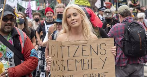 Topless Extinction Rebellion Activist Returns To Ditch Bra By Downing