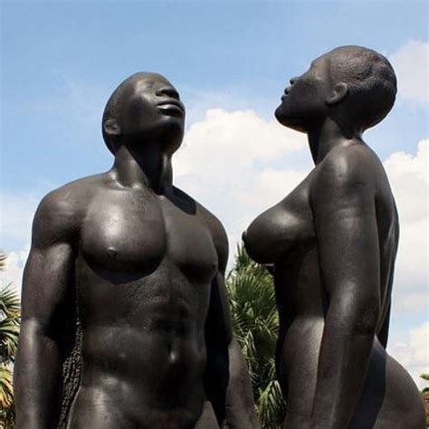 two black statues standing next to each other