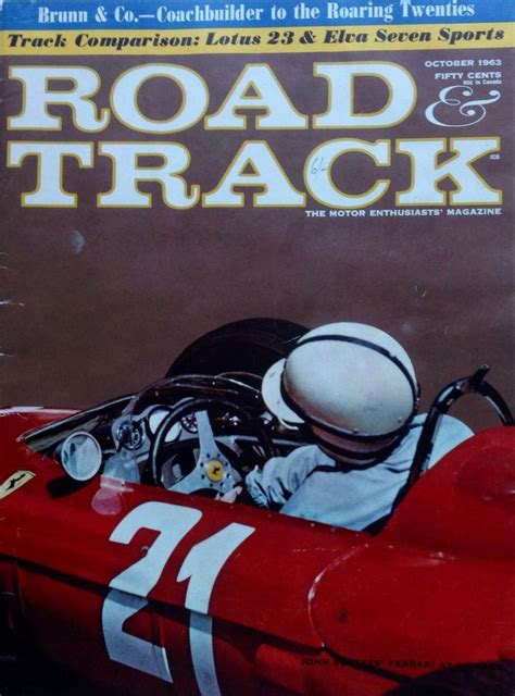 The Cover Of Road And Track Magazine Shows A Man Driving A Race Car