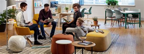 Employees Conversing In Office Social Space Furnished With Openest