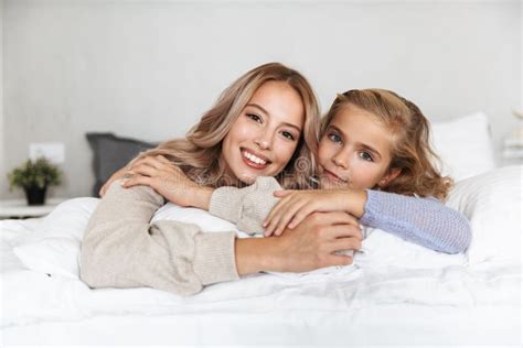 Happy Girls Sisters On Bed In Bedroom At Home Posing Smiling Stock Image Image Of Happy