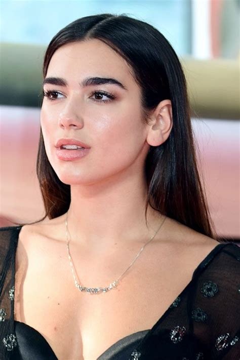 Dua lipa added a shock of color with a sweep of red lipstick. Dua Lipa's Hairstyles & Hair Colors | Steal Her Style