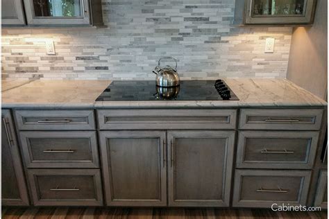 Open Concept Kitchen Featuring Storm Gray Stained Cabinets With Glass