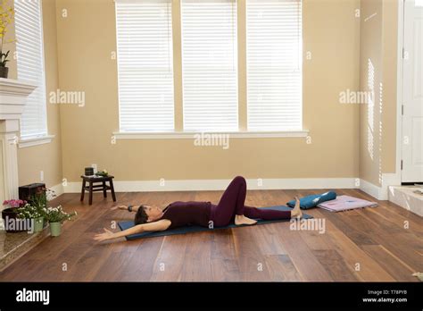Yoga Pose On Back Arms Overhead One Knee Bent Stock Photo Alamy