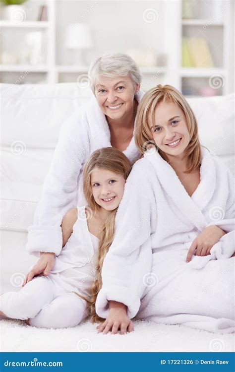 Grandmother With Mother And Adult Daughter Relaxing On Sofa Royalty Free Stock Image