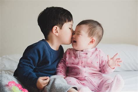 Big Brother Giving Baby Sister A Kiss By Stocksy Contributor Lauren
