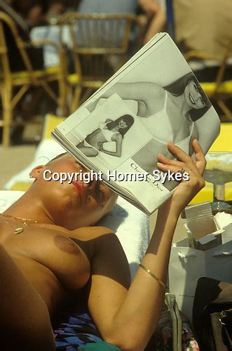 Cannes Film Festival Topless Woman On Beach Reading Magazine Homer Sykes
