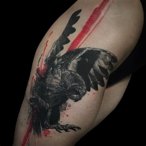 A Black And Grey Tattoo With An Eagle On It S Arm Painted Red