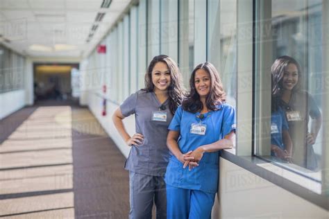 Nurses Smiling In Hospital Hallway Stock Photo Dissolve