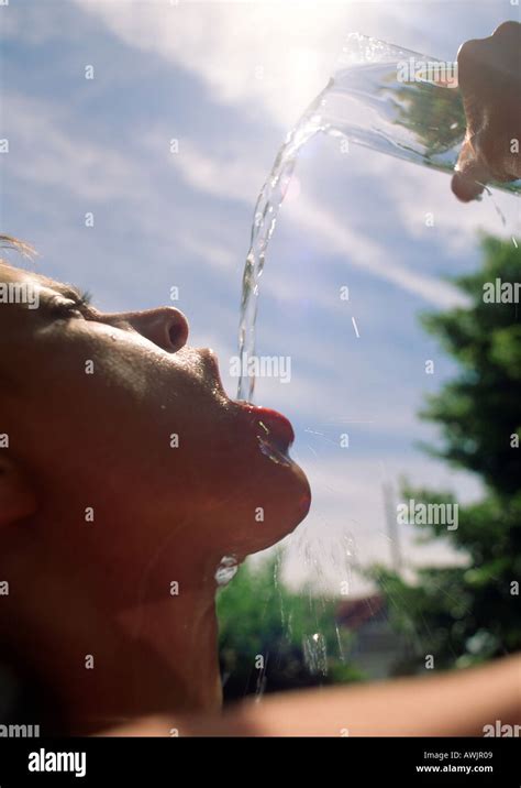 Woman Pouring Water Into Mouth Under Sun Stock Photo Alamy