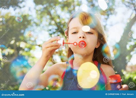 Bubbles And Summer Vacation Shot Of A Cute Young Girl Blowing Bubbles