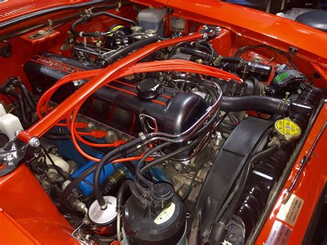 The Engine Compartment Of An Orange Sports Car