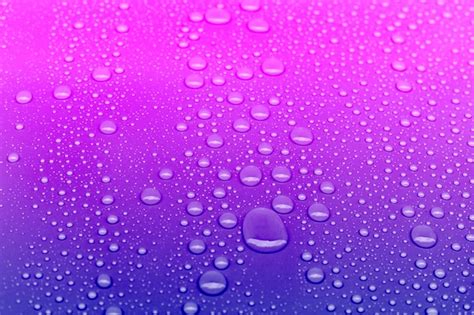 Premium Photo Neon Colored Water Drops Background