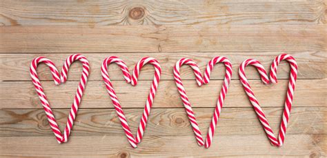 Candy Canes Heart Shaped On Wooden Background Stock Photo
