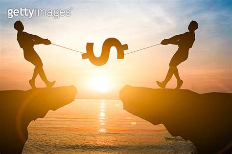 Silhouette Men Pull Us Dollar Sign On Mountain With Sunlight Us Dollar