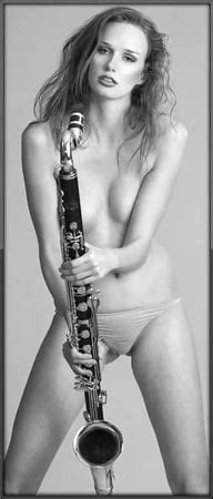 See And Save As Nude Girl Blows And Play A Clarinet Music Instrument