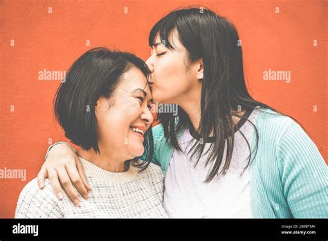 Hija Asiática Besando A Mamá En El Día De La Madre Feliz Familia