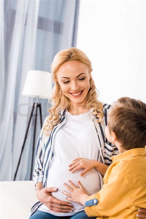 Happy Pregnant Mother And Son Touching Belly Stock Image Colourbox