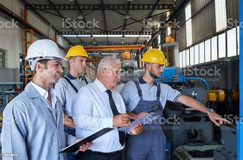 Supervisor And Workers In Factory Stock Photo Download Image Now