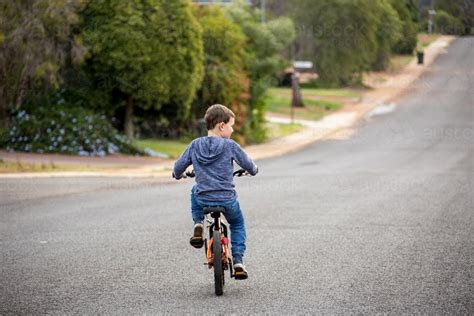 Image Of Child Riding Bike On Road With No Helmet Austockphoto