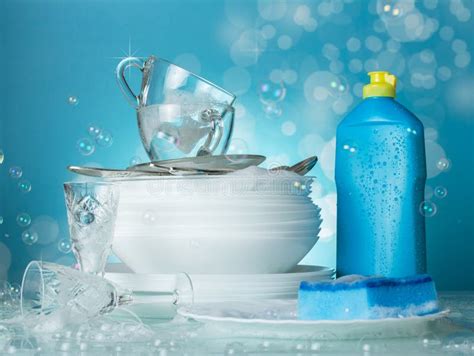 Clean Washed Dishes Dishwashing And Soap Bubbles On Blue Stock Image