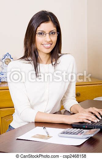 An Indian Secretary Using Laptop At Her Desk CanStock