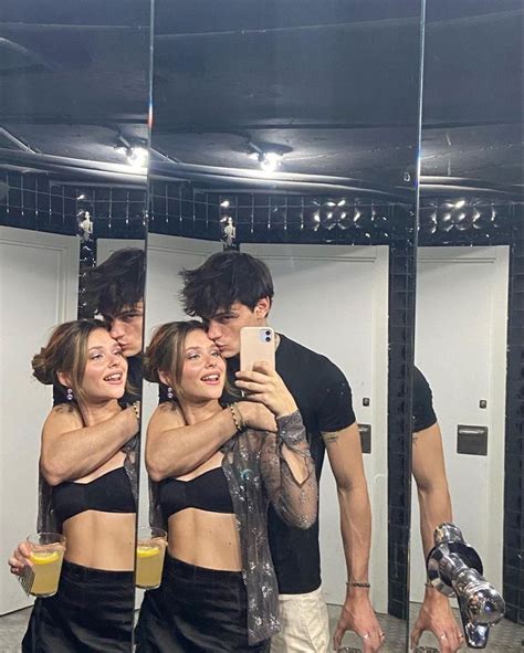 three people taking a selfie in front of a mirror