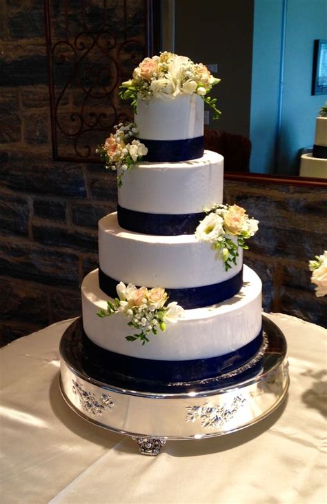Simple 4 Tier Buttercream Wedding Cake With Navy Blue Ribbon And Fresh