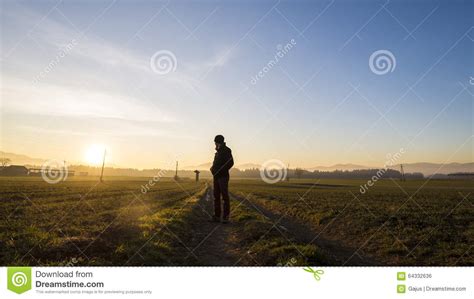 Young Man Standing On Country Road In A Beautiful